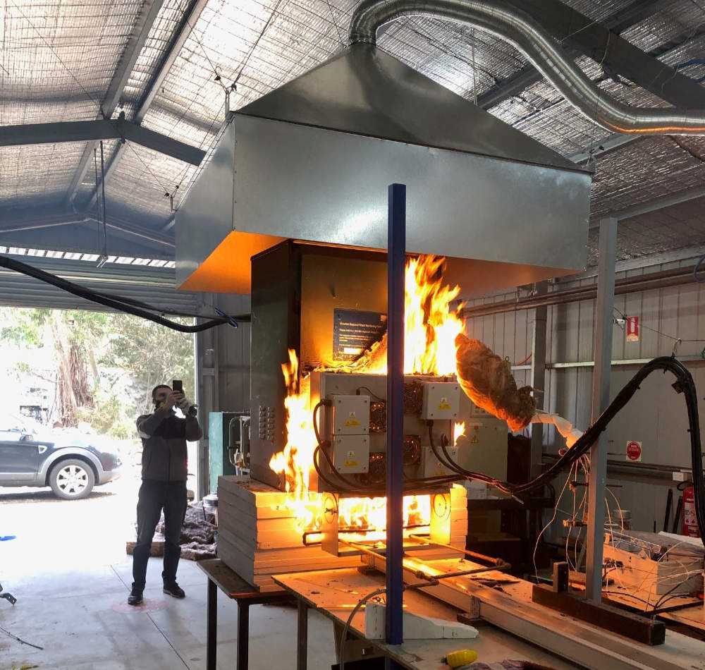 Controlled fire test of electrical equipment in lab.