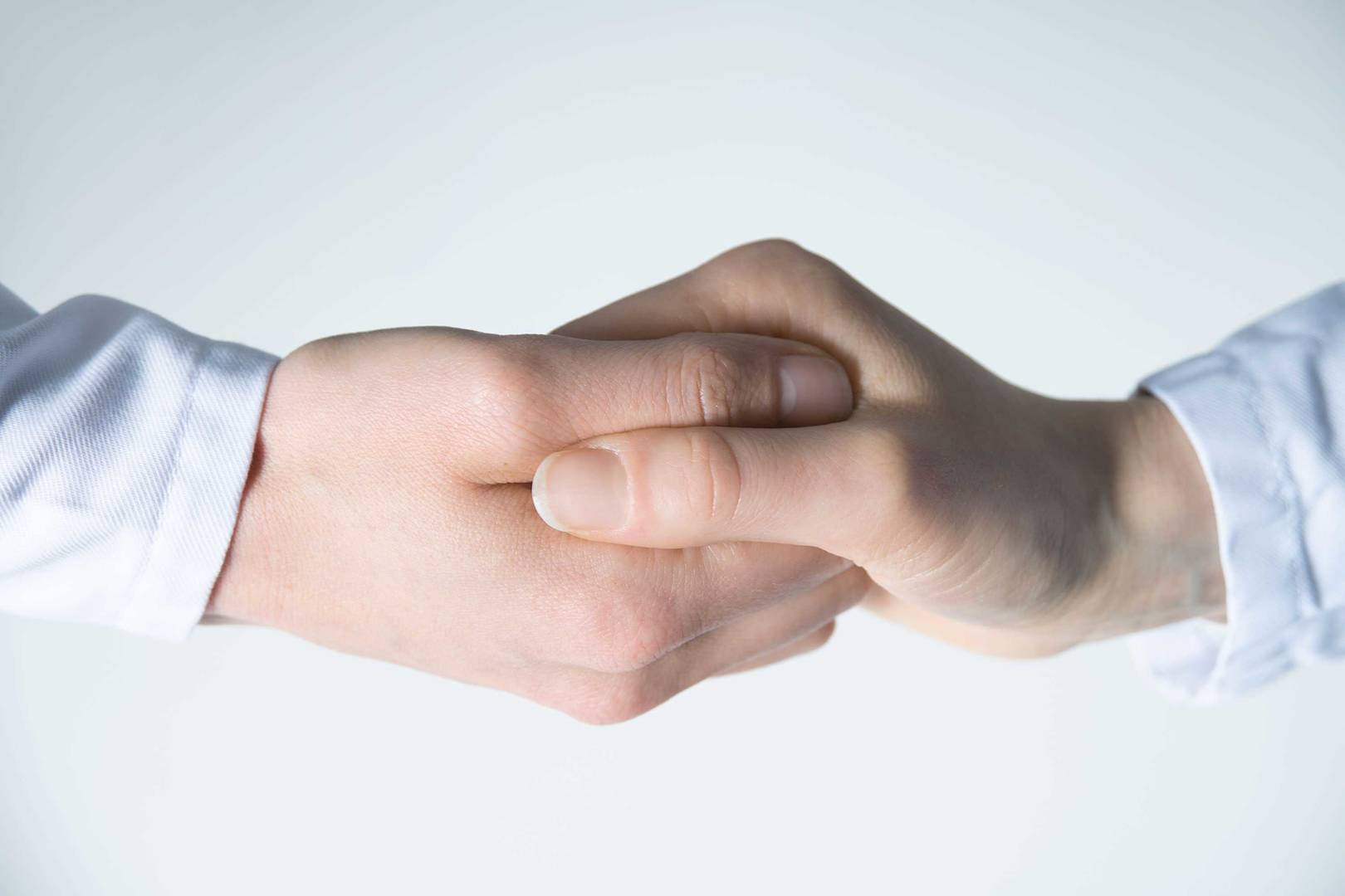 Two people working together hand in hand