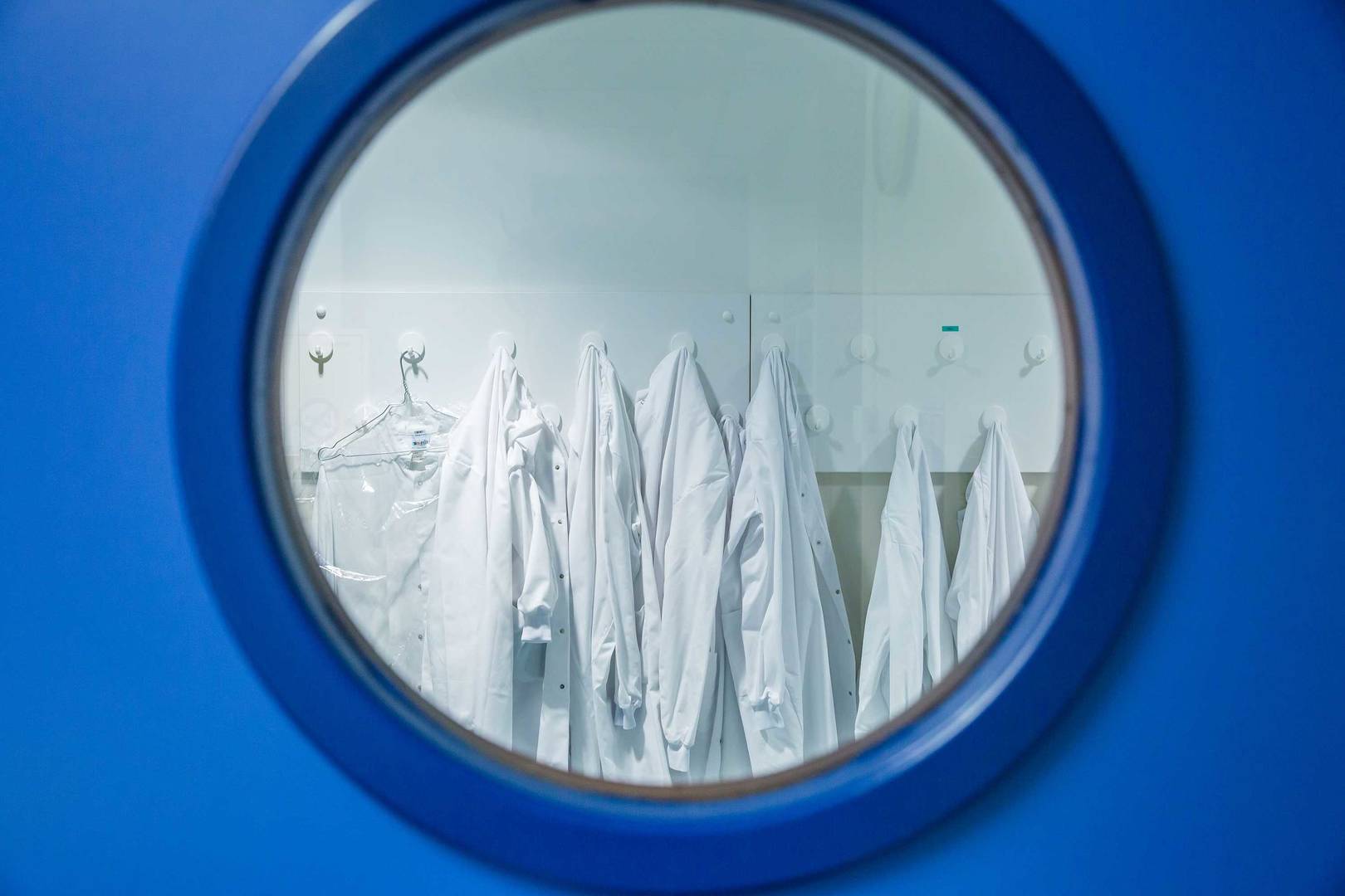 Blue door showing through a glass lab coats