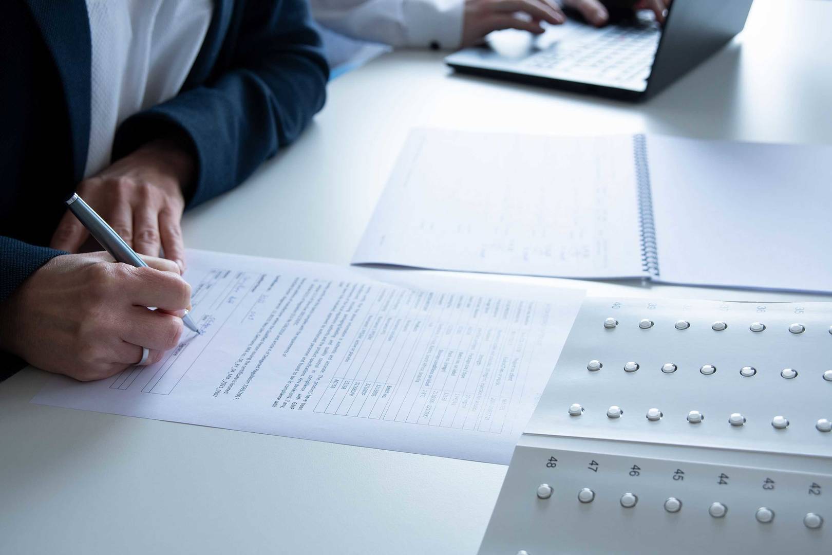 Two printed documents are placed on a table for regulatory review