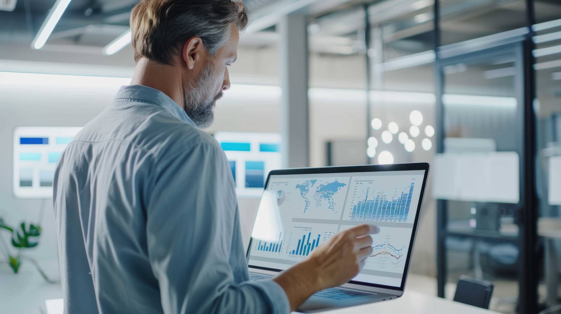 Biostatistician analyzing data on a laptop screen in a modern office setting