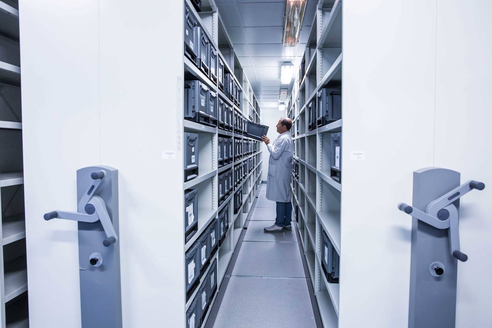 Man in warehouse managing logistics and depot solutions for clinical trial supplies