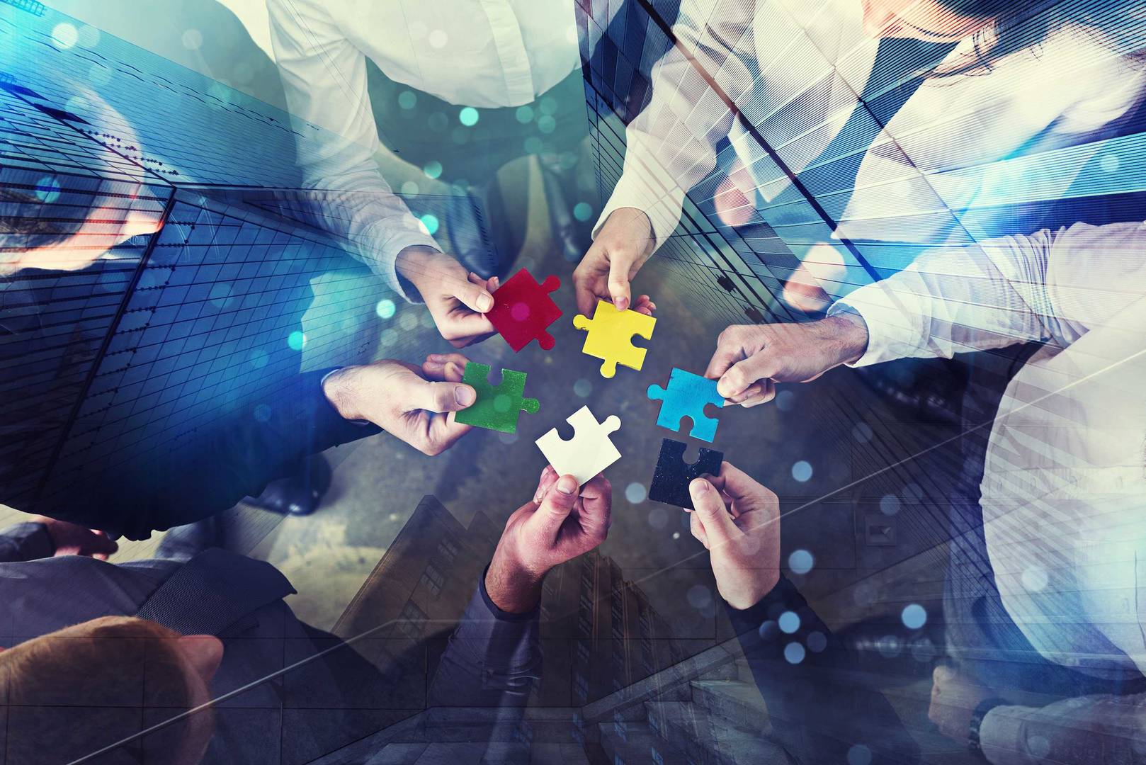 Business people join puzzle pieces in office, concept of cinical trial supply services