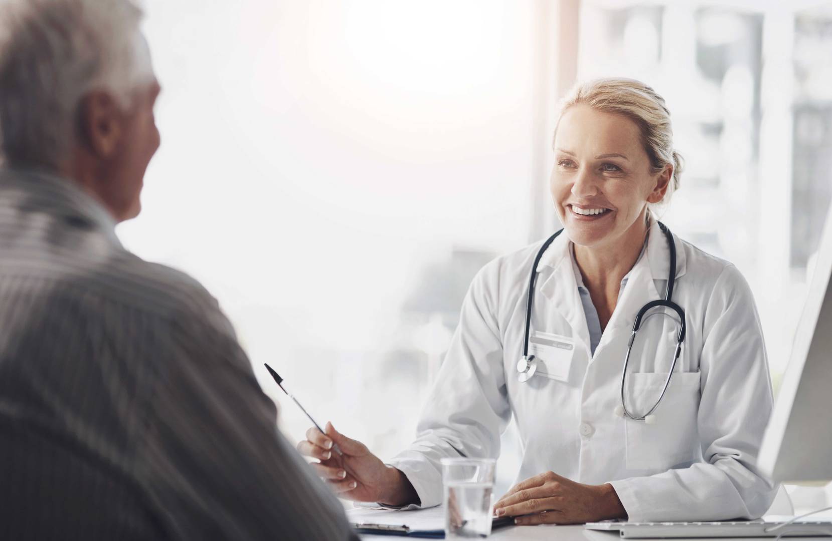 Doctor consulting with a patient about clinical trial recruitment