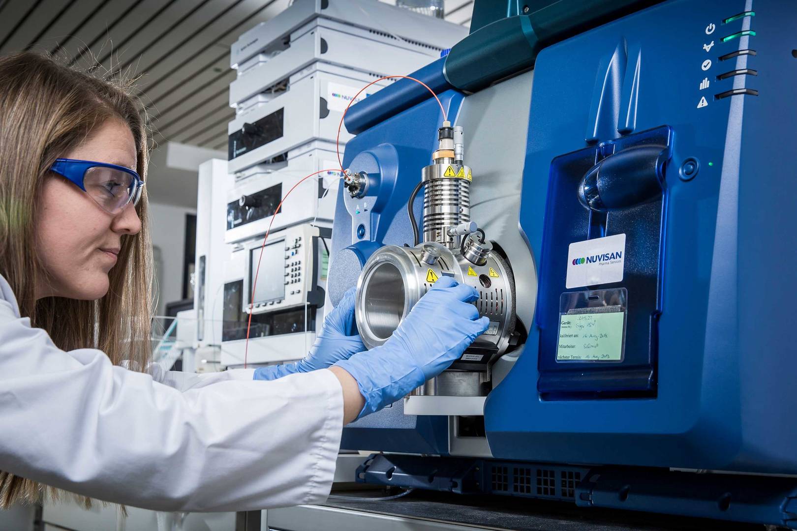 A scientist using a mass spectrometer to analyse samples