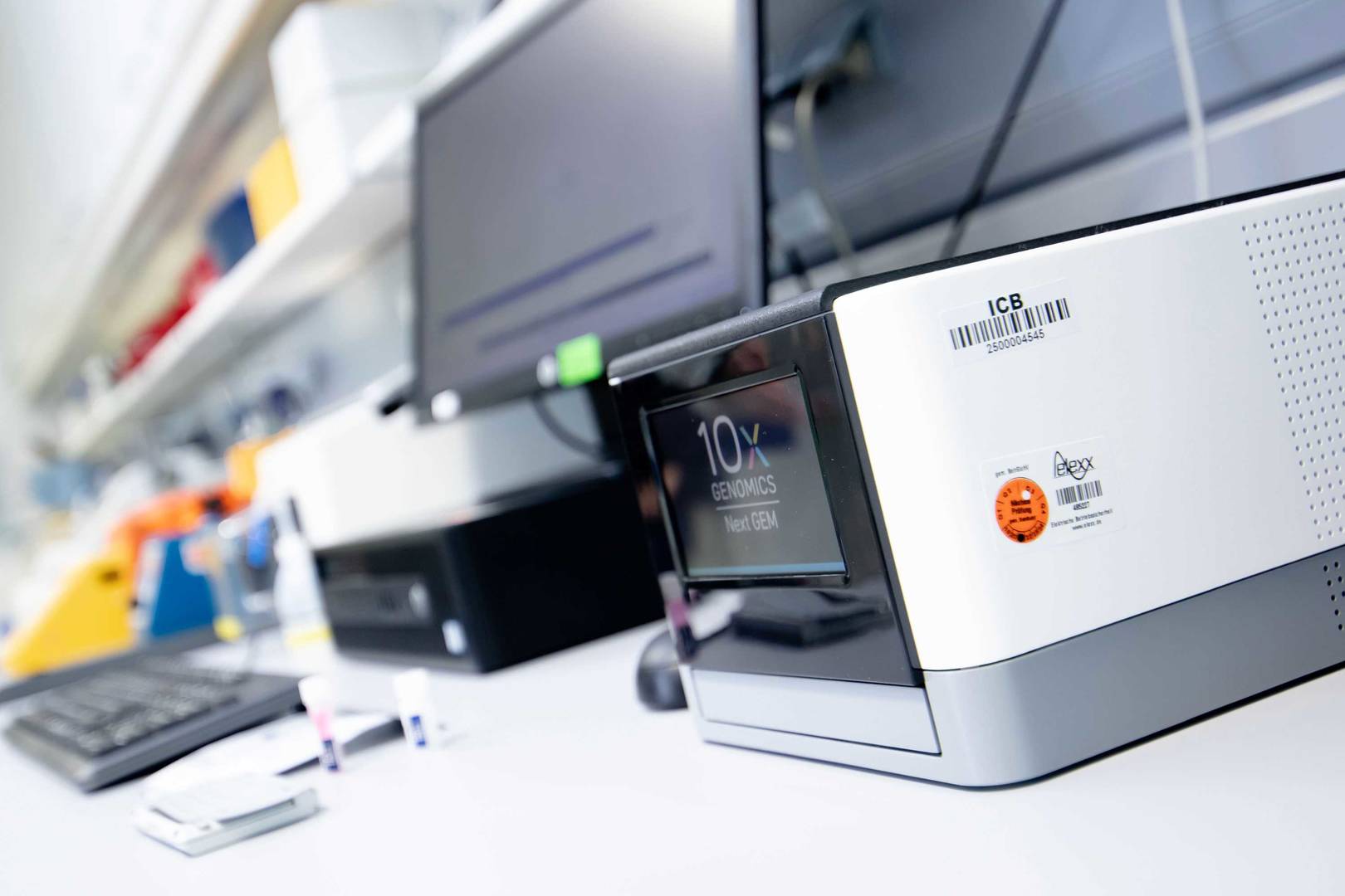 A 10x Chromium instrument is ready for loading of samples. The device performs automated cell partitioning and barcoding for single cell sequencing. 