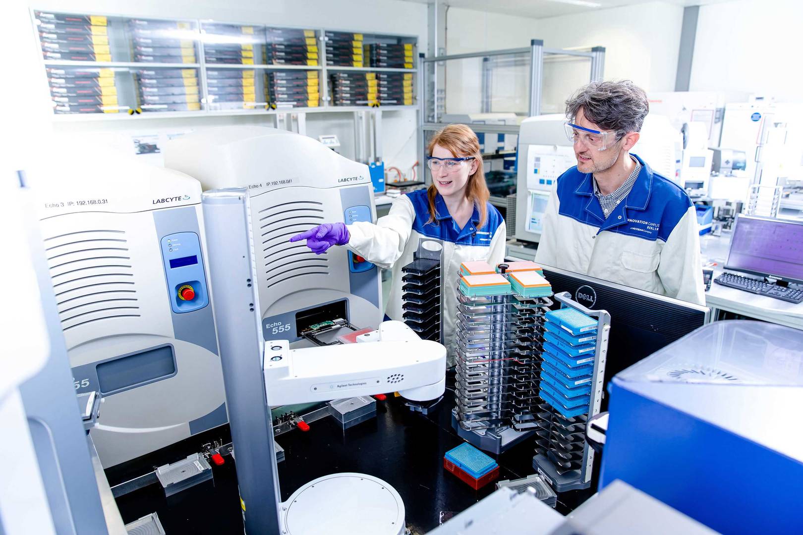 Young scientists explains an automated screening system to another person. 