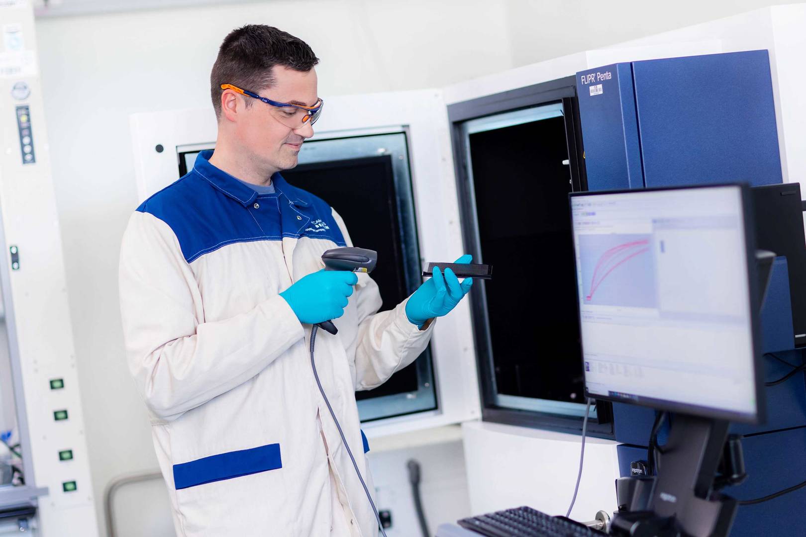 Lab technician operating a FLIPR® Penta reader