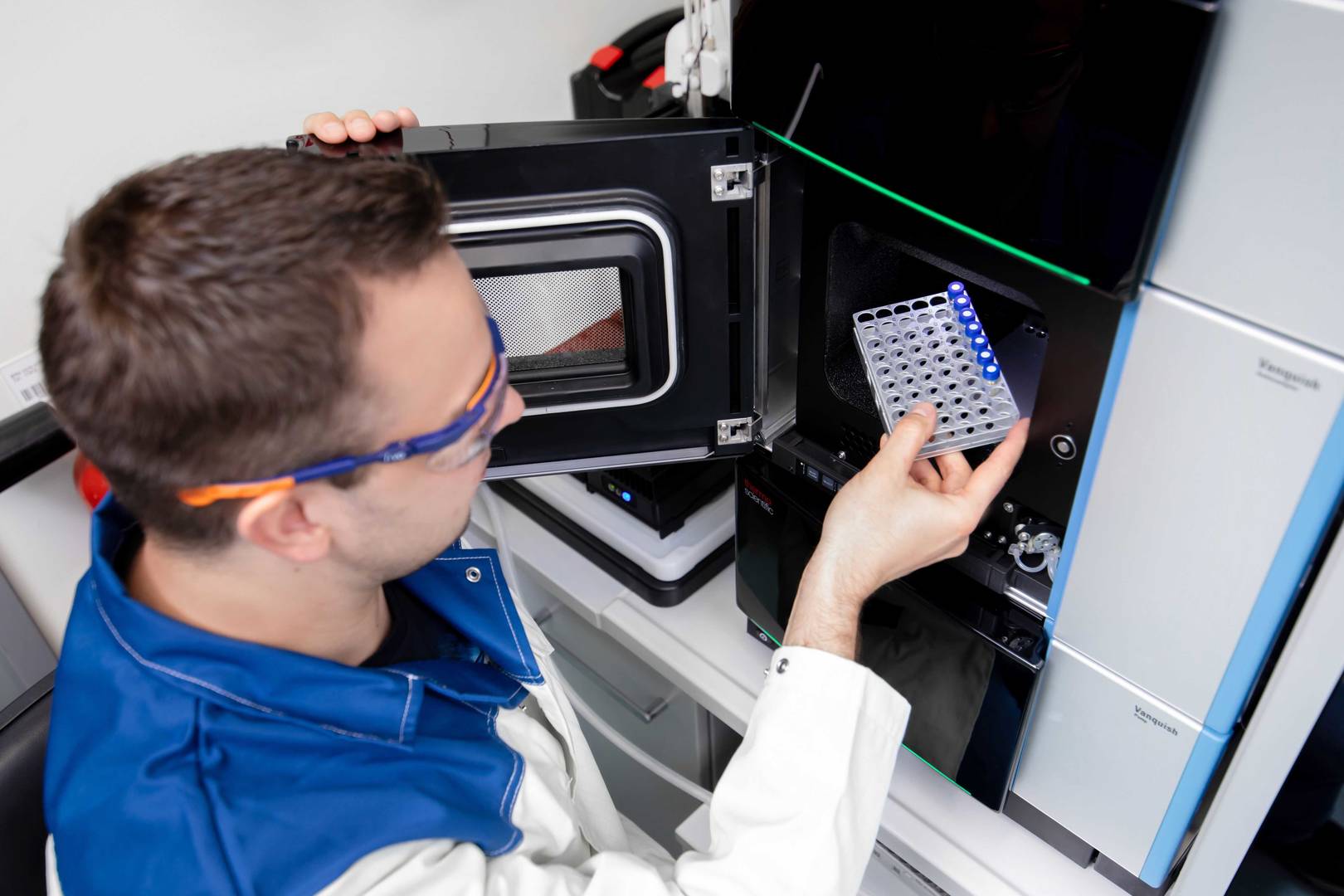 Lab technician loads samples into the instrument for FSEC analysis