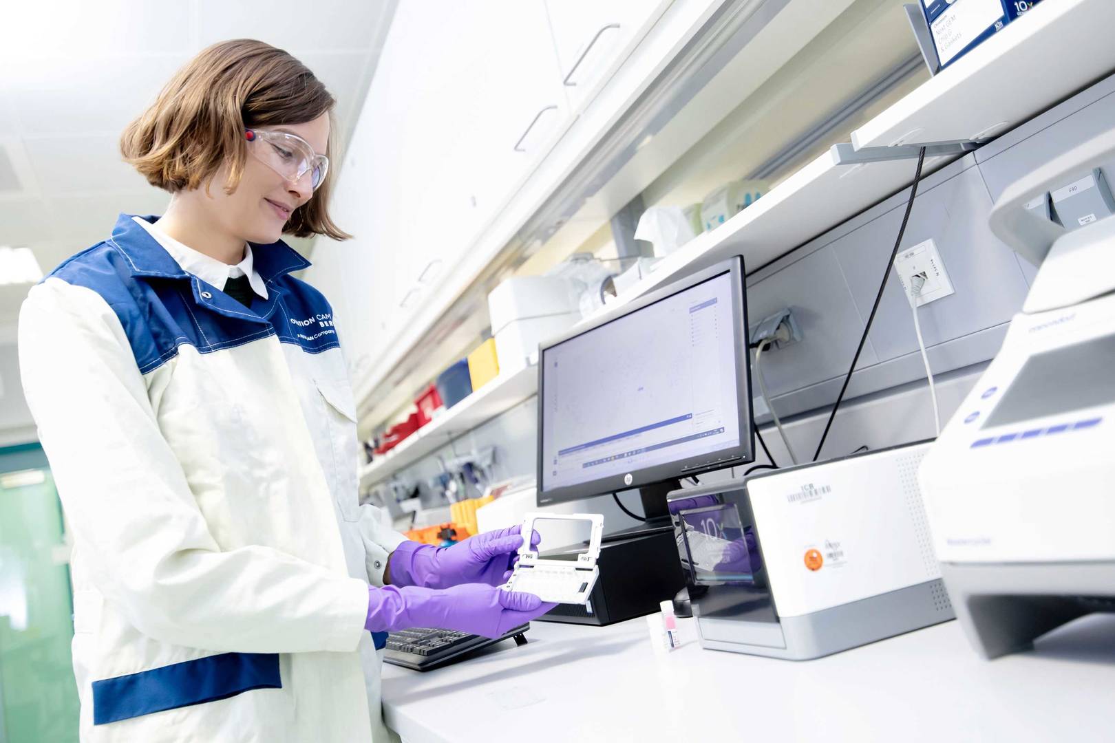 Female laboratory scientist holding a flow chamber  
