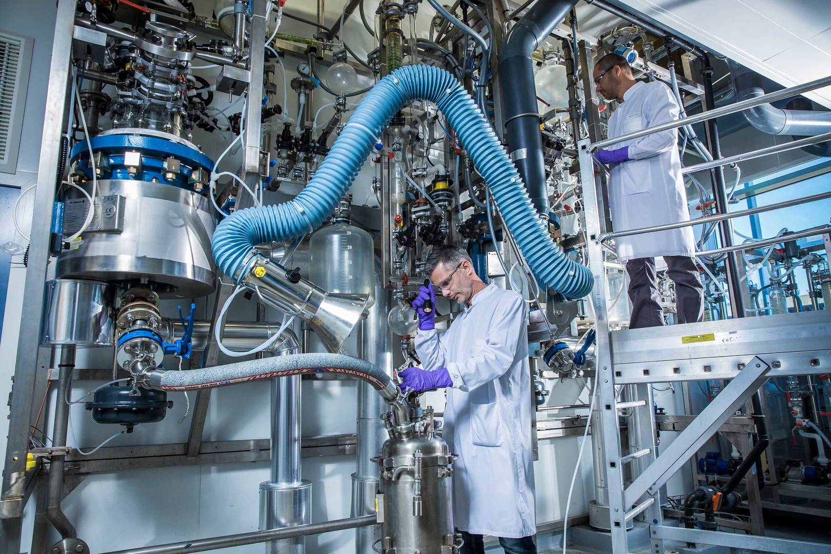 Two lab-coated technicians work in a kilolab