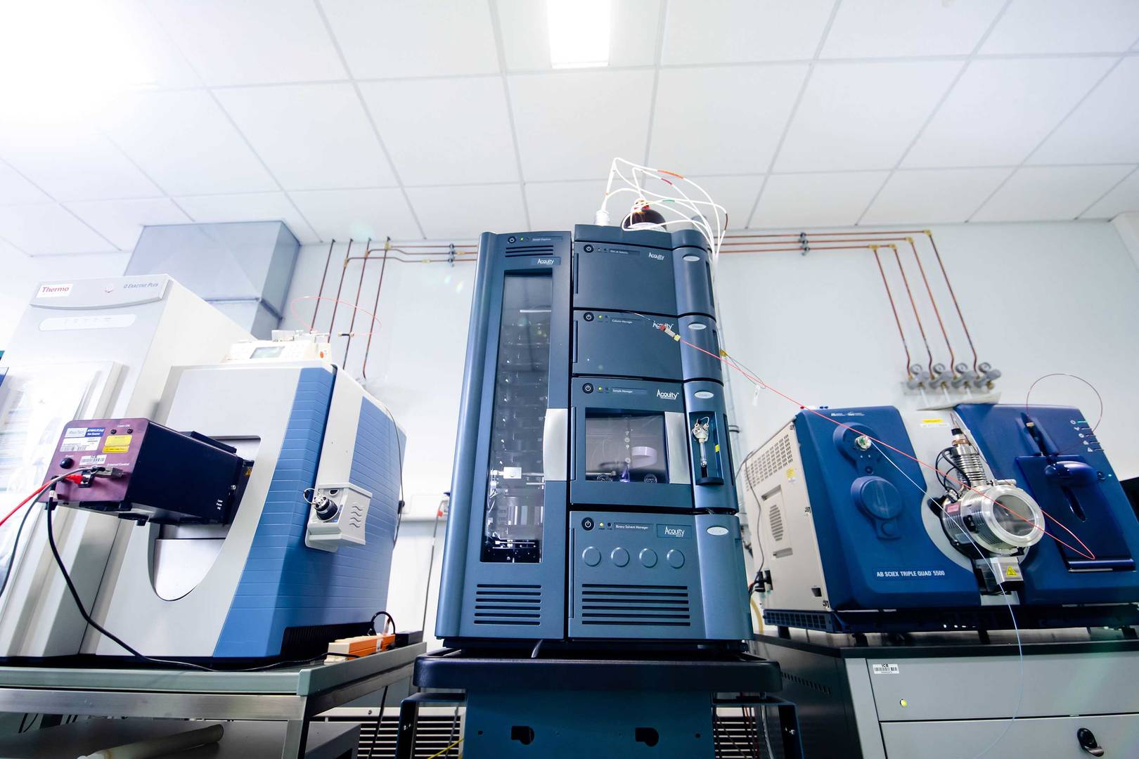 A collection of HPLC-MS machines arranged on a benchtop, illustrating sophisticated technology for mass spectrometry applications. 